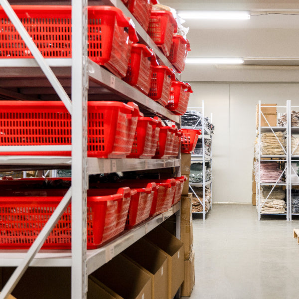 Storage room with red bins on shelves